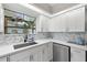 Bright kitchen with white cabinets, quartz countertops and a blue and white backsplash at 1030 Charles St, Clearwater, FL 33755