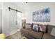 Cozy living room featuring a brown couch, barn door, and artwork at 1030 Charles St, Clearwater, FL 33755