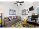 Bright home office with comfortable couch, workspace, and large artwork at 1030 Charles St, Clearwater, FL 33755