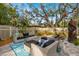 Relaxing patio seating area with wicker furniture under shade trees at 1030 Charles St, Clearwater, FL 33755