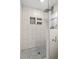 Modern shower with patterned tile floor and glass enclosure at 1030 Charles St, Clearwater, FL 33755