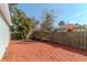 Backyard with mulch, trees, and wooden fence at 1039 10Th N St, St Petersburg, FL 33705