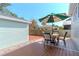 Deck with patio table and chairs, umbrella, and backyard view at 1039 10Th N St, St Petersburg, FL 33705