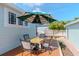 Deck with patio set, umbrella, and view of backyard at 1039 10Th N St, St Petersburg, FL 33705