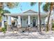 Charming light-green house with a large front porch and stone pillars at 1039 10Th N St, St Petersburg, FL 33705