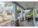 Relaxing front porch with tiled floor and hanging plants at 1039 10Th N St, St Petersburg, FL 33705