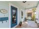 Front porch with a blue door and a hanging swing at 1039 10Th N St, St Petersburg, FL 33705