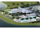 Aerial view of community pool, clubhouse, and surrounding landscape at 11822 Starbright Path, Venice, FL 34293