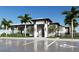 Modern clubhouse exterior with palm trees and ample parking at 11822 Starbright Path, Venice, FL 34293