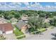 Aerial view of a house with a yard, driveway, and surrounding homes at 122 Orange Bud Way, Plant City, FL 33563