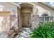 Front entryway with brick columns, light fixture, and lush landscaping at 122 Orange Bud Way, Plant City, FL 33563