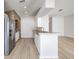 Kitchen with white cabinets, stainless steel appliances, and brick accent wall at 122 Orange Bud Way, Plant City, FL 33563