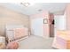 Charming Bedroom with pink walls and a white crib at 12405 Crestridge Loop, New Port Richey, FL 34655