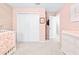 Charming bedroom with pink walls, a crib, and ample closet space at 12405 Crestridge Loop, New Port Richey, FL 34655