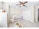 Bright Bedroom features a crib, dresser, and plenty of space for baby at 12405 Crestridge Loop, New Port Richey, FL 34655