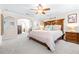 King-size bed in a well lit Primary bedroom with ensuite bathroom at 12405 Crestridge Loop, New Port Richey, FL 34655