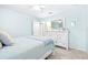 Serene bedroom with light blue walls, a comfortable bed, and a white dresser at 12405 Crestridge Loop, New Port Richey, FL 34655