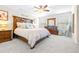 Main bedroom with large bed and wooden furniture at 12405 Crestridge Loop, New Port Richey, FL 34655