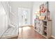 Bright entryway with wood floors, storage bench, and decorative console table at 12405 Crestridge Loop, New Port Richey, FL 34655