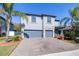 Two-story house with gray siding, stone accents, and a two-car garage at 12405 Crestridge Loop, New Port Richey, FL 34655