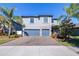 Two-story house with gray siding, stone accents, and a two-car garage at 12405 Crestridge Loop, New Port Richey, FL 34655