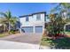 Two-story house with gray siding, stone accents, and a two-car garage at 12405 Crestridge Loop, New Port Richey, FL 34655