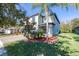 Two-story house with gray siding, stone accents, and a two-car garage at 12405 Crestridge Loop, New Port Richey, FL 34655