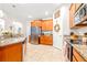 Kitchen with wood cabinets, granite countertops, and stainless steel appliances at 12405 Crestridge Loop, New Port Richey, FL 34655