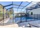 Private pool access with a security gate and paved patio at 12405 Crestridge Loop, New Port Richey, FL 34655