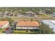 Aerial view showcasing the two-story home with a red tile roof, parking, and neighborhood at 1264 Riserva Ln, Palm Harbor, FL 34683