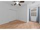 Bedroom featuring hardwood floors, a ceiling fan, closet, and window with curtains at 1264 Riserva Ln, Palm Harbor, FL 34683