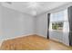 Bright bedroom with hardwood floors, modern lighting, and large window with natural light at 1264 Riserva Ln, Palm Harbor, FL 34683