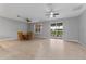 Open concept dining room with tile floors, ceiling fans, and access to a screened patio at 1264 Riserva Ln, Palm Harbor, FL 34683