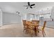 Open-concept dining room with wooden table, six chairs, and an adjacent modern kitchen at 1264 Riserva Ln, Palm Harbor, FL 34683