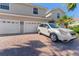 Charming two-story home with three-car garage and brick paver driveway at 1264 Riserva Ln, Palm Harbor, FL 34683