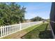 White picket fence encloses a grassy backyard at 14638 Strathglass Dr, Hudson, FL 34667