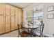 Bright breakfast nook features a round table with four chairs and built-in cabinetry at 14638 Strathglass Dr, Hudson, FL 34667