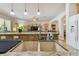 Kitchen island with a double sink, granite countertop, and a view into the living room at 14638 Strathglass Dr, Hudson, FL 34667