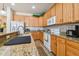 Kitchen with granite countertops, wood cabinets, and stainless steel appliances at 14638 Strathglass Dr, Hudson, FL 34667