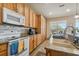 View of kitchen with granite countertops, wood cabinets, and an island at 14638 Strathglass Dr, Hudson, FL 34667