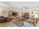 Relaxing living room features leather sofas, a large TV, and a ceiling fan at 14638 Strathglass Dr, Hudson, FL 34667