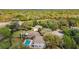 Aerial view showing house, pool, and surrounding landscape at 1542 Mccrea Dr, Lutz, FL 33549