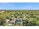 Aerial view of a two-story house with a pool, nestled in a lush, wooded neighborhood at 1542 Mccrea Dr, Lutz, FL 33549