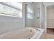 Bathroom with a tub and shower, and a window at 1542 Mccrea Dr, Lutz, FL 33549