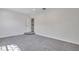 Bright bedroom with gray carpeting and access to upper hallway at 1542 Mccrea Dr, Lutz, FL 33549