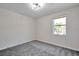 Bright bedroom featuring a window with natural light and carpet flooring at 1542 Mccrea Dr, Lutz, FL 33549