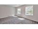 Well-lit bedroom featuring carpet flooring and large windows at 1542 Mccrea Dr, Lutz, FL 33549