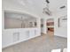 Bright dining room with granite floors and a view into the kitchen at 1542 Mccrea Dr, Lutz, FL 33549