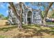 Front view of a two story house with a large yard and driveway at 1542 Mccrea Dr, Lutz, FL 33549