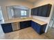 Kitchen features granite countertops and dark blue cabinets at 1542 Mccrea Dr, Lutz, FL 33549